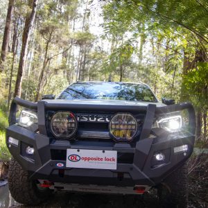 Front Front view of the Opposite Lock premium steel bull bar fitted to a 2024 Isuzu D-Max, showing the 64mm tube loops and driving light mounts Fitted Opposite Lock bull bar installed on a silver 2024 Isuzu D-Max parked on a forest 4WD track